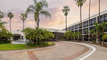 The San Diego venue at dusk, framed by palm trees